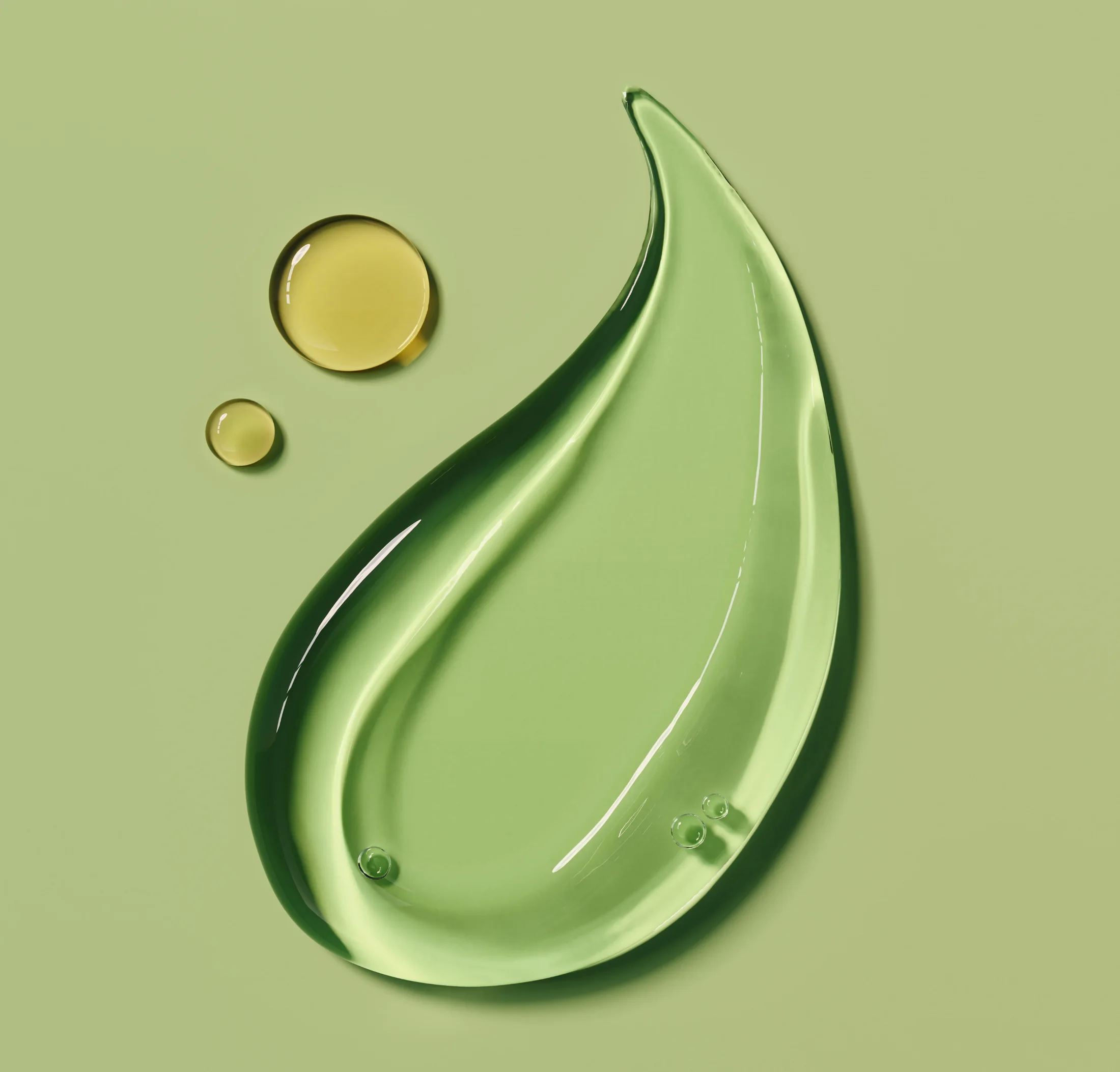 A translucent green skincare gel with a sculptural sweep and delicate droplets.