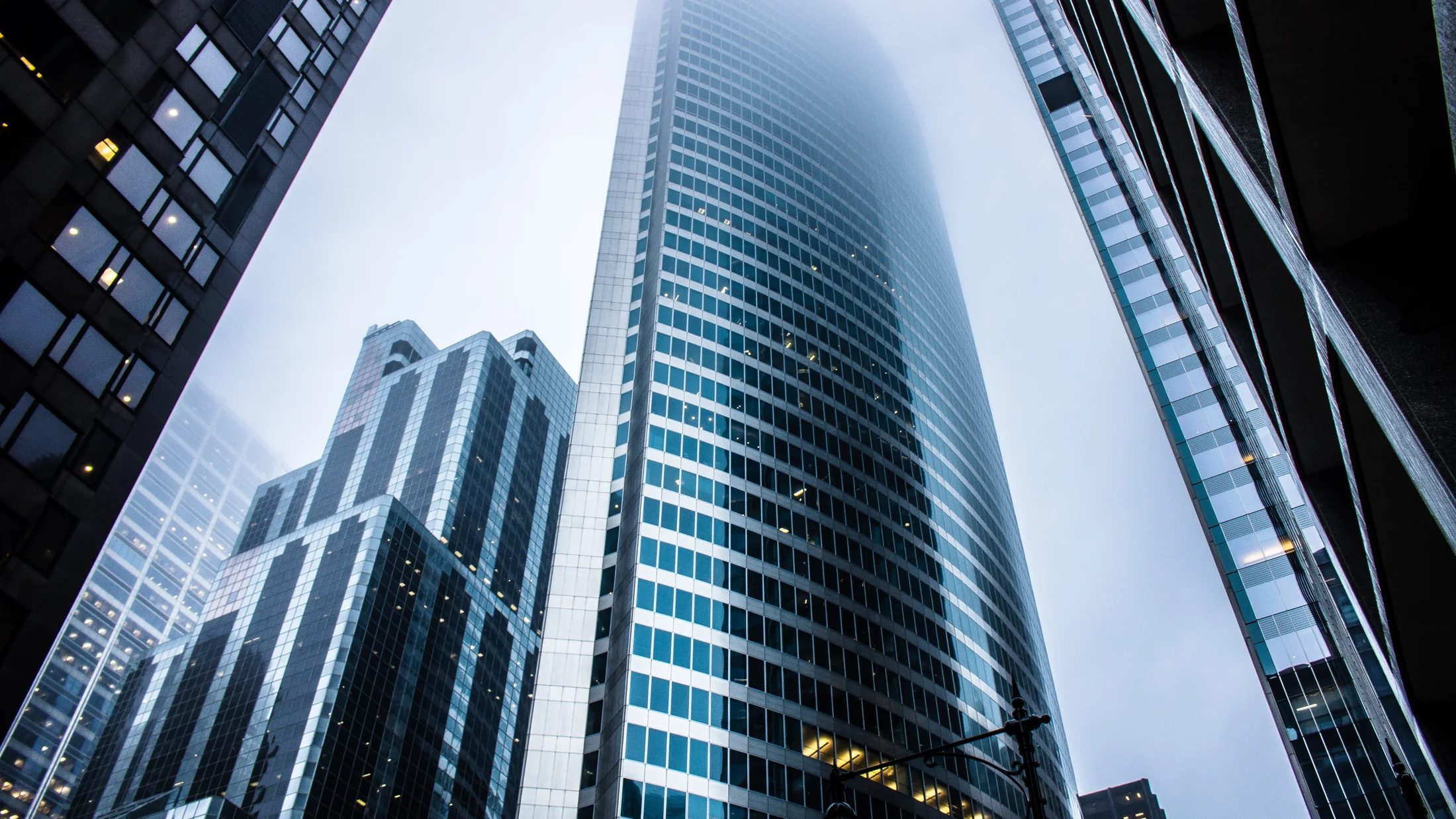 A view upward between modern city buildings