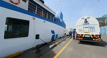 A road tanker alongside a vessel at a quay
