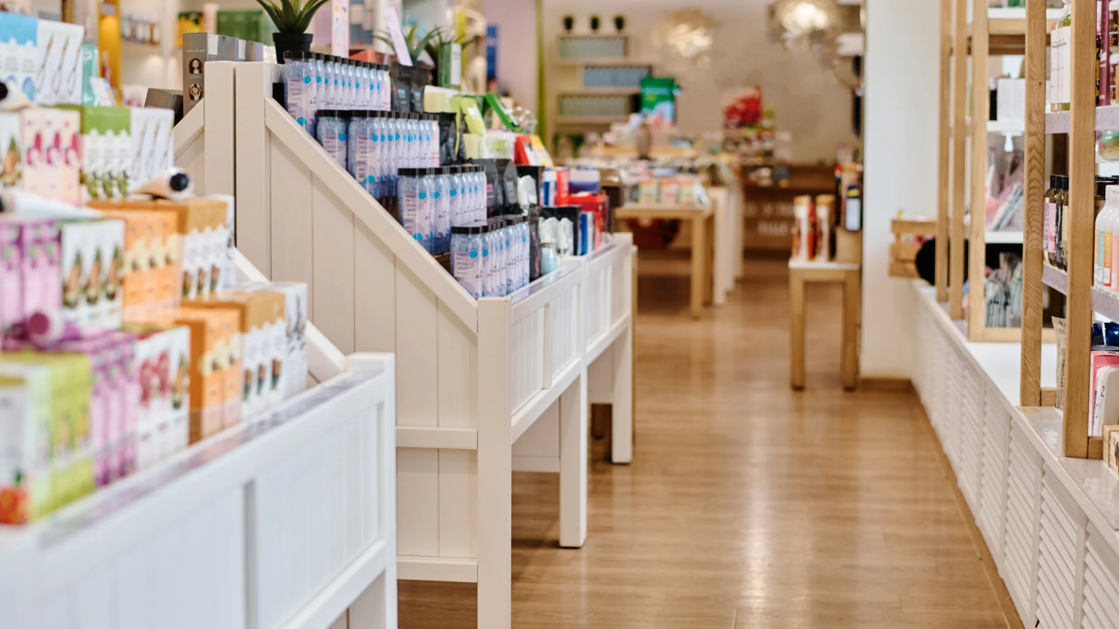 Beauty products displayed on shelves in a bright, welcoming retail space.